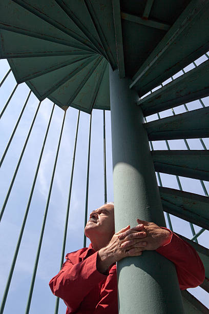 istock Man against a metal colon, fire escape 171578695