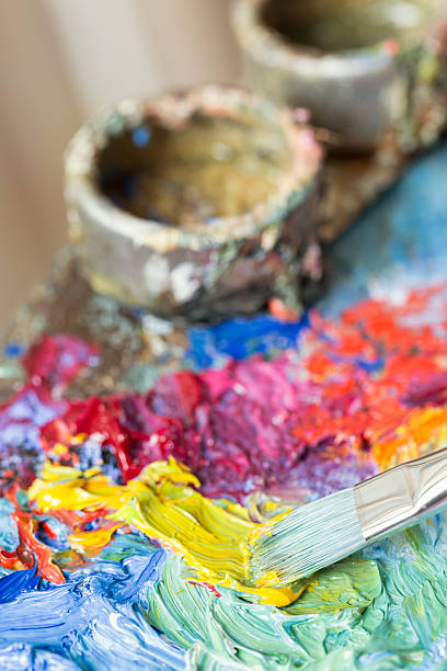 istock Paintbrush with oil paint on a classical palette 171579058