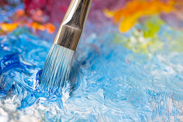 istock Paintbrush with oil paint on a classical palette 171579062