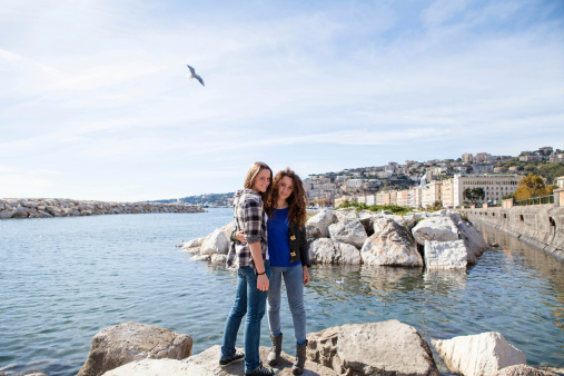 Two Beautiful Girls on Naples Promenade, Italy, looking at camera.