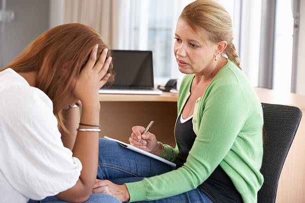 istock Young woman is comforted by counselor during a session 171579397