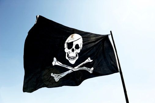 Jolly Roger or pirate ship flag waving 3D Render with flagpole and blue sky, pirate ship flag in Golden Age of Piracy, skull and crossbones, Pirates of Caribbean sea and Black Pearl. 3d illustration