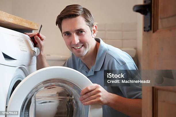 Engineer Mending Domestic Washing Machine Stock Photo - Download Image Now - Repairing, Washing Machine, Appliance