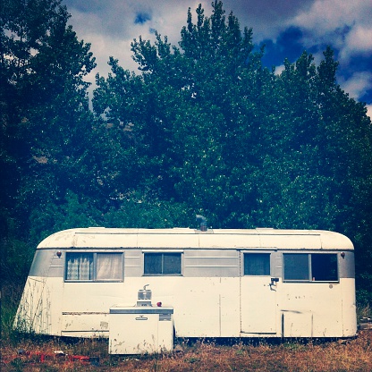 A vintage trailer sitting abandoned in Oregon.  Photo captured using an iPhone and processed with Snapseed.