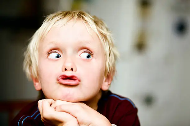 Wide eyed, a boy grimaces as he looks to the right of frame, right where you can add your message. Shot with Canon EOS 1Ds Mark III.