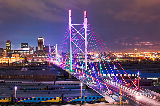 Nelson Mandela Bridge sunset Multicolored lighting on Nelson Mandela Bridge in Johannesburg city. johannesburg photos stock pictures, royalty-free photos & images