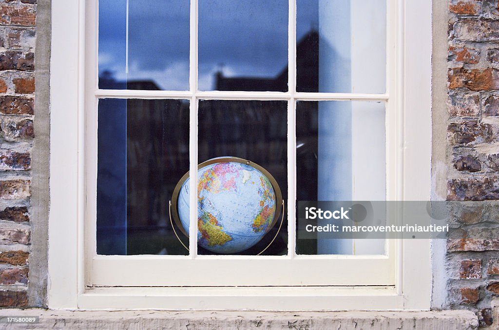 Window on the world - Una finestra sul mondo The world (a globe) seen through a window. Durham, England. Globe - Navigational Equipment Stock Photo