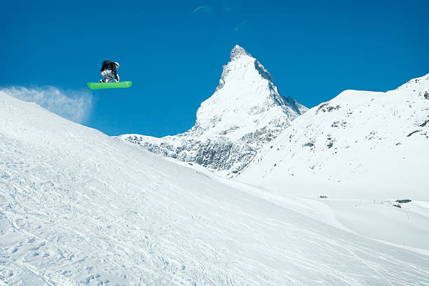 Snowboarder in jump Snowboarder in jump, Switzerland MatterhornSEE ALSO: air jump stock pictures, royalty-free photos & images