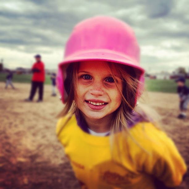 a little girl playing baseball. shot with an iphone 4s using instagram filters. 