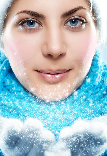 istock winter woman blowing a snow to camera 171580808