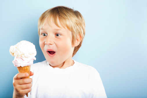 inspired by the anticipation of sweet things, a Black boy stands with three ice cream cones in waffle cups. The child enjoys the taste and coolness of ice cream in hot summer.
