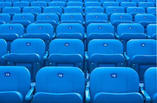 Rows of blue stadium seats.