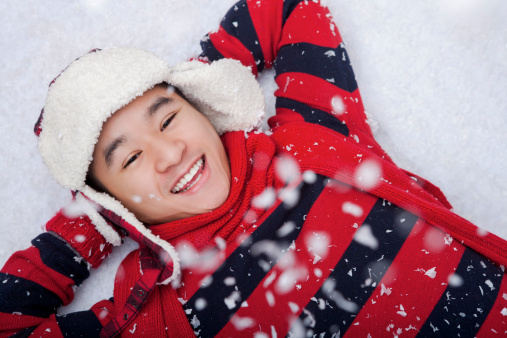 Happy man laying on snow