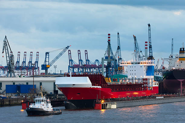 istock tug boat helping to undock a cargo ship in hamburg 171581152