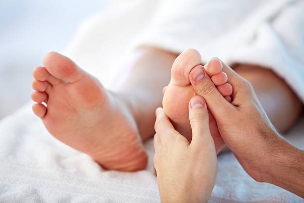 Reflexology Reflexology foot massage foot massage stock pictures, royalty-free photos & images