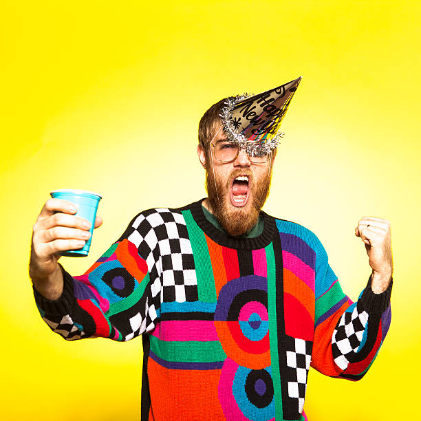 Crazy New Years Party Guy A nerdy party guy toasting his drink, wearing an awful sweater. His New Years party hat is falling off because he's so excited to party! nerd sweater stock pictures, royalty-free photos & images