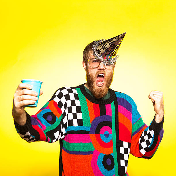 Crazy New Years Party Guy A nerdy party guy toasting his drink, wearing an awful sweater. His New Years party hat is falling off because he's so excited to party! party funny stock pictures, royalty-free photos & images