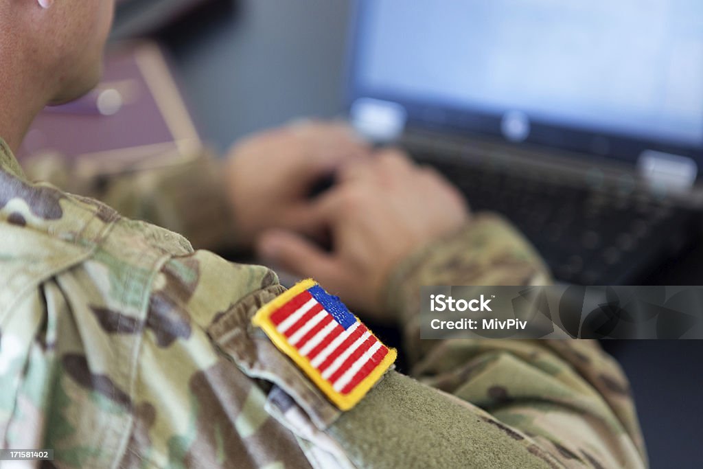 American soldier working on laptop unrecognizable American soldier writing on a laptop Military Stock Photo