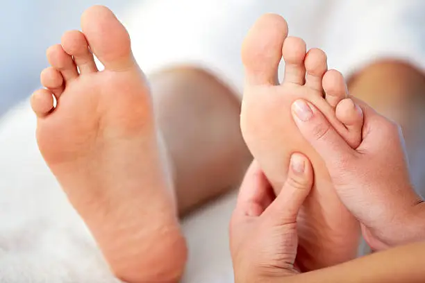 Close-up of female hands pampering feet