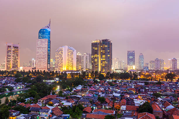 Jakarta by Night, Indonesia High angle view over central Jakarta showing the skyline and inner city residential buildings in the foreground. jakarta slums stock pictures, royalty-free photos & images