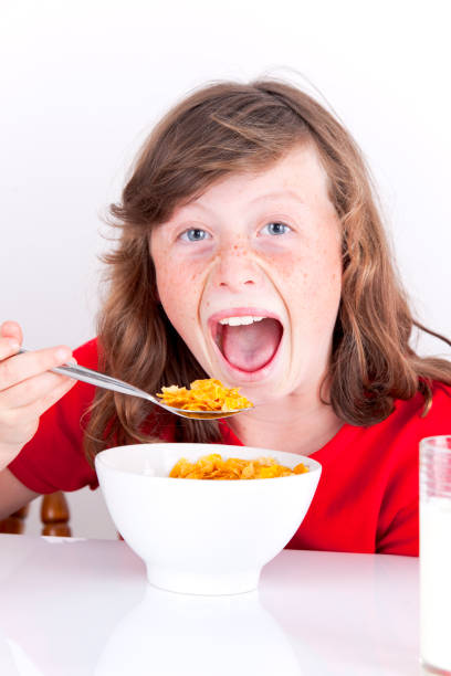 istock 9-year-old Girl Eating Breakfast 171581725