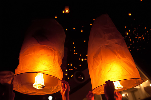 Lanterns filling with hot air before they are launched into the air at the Loi Krathong festival in Chiang Mai, Thailand. In Thai, these lanterns are known as Khom Loi which are actually small hot air balloons.