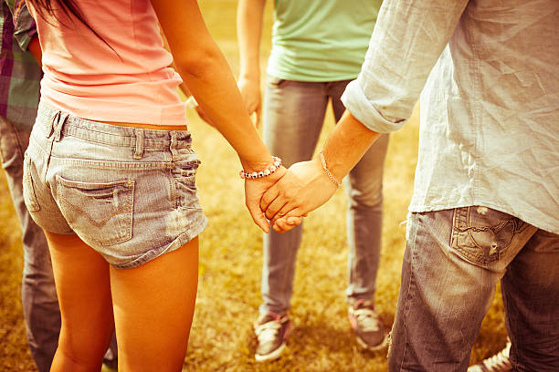 istock Young people holding hands in row 171581810