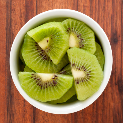 Kiwi fruit on wooden background with copy space