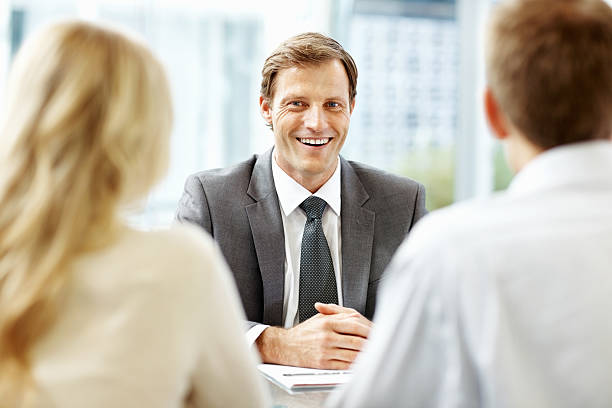 istock Executive smiling and discussing with his associates 171582436