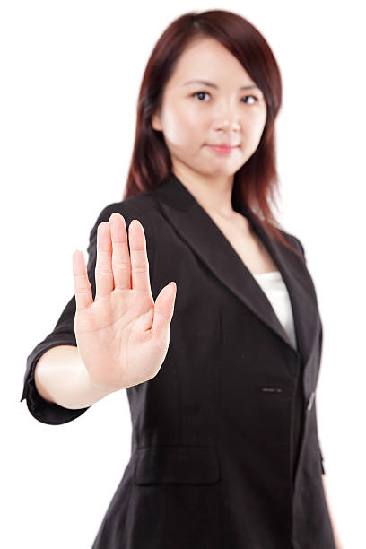 китайский деловая женщина жестикулировать остановки на белом фоне - determination isolated on white vertical looking at camera стоковые фото и изображения