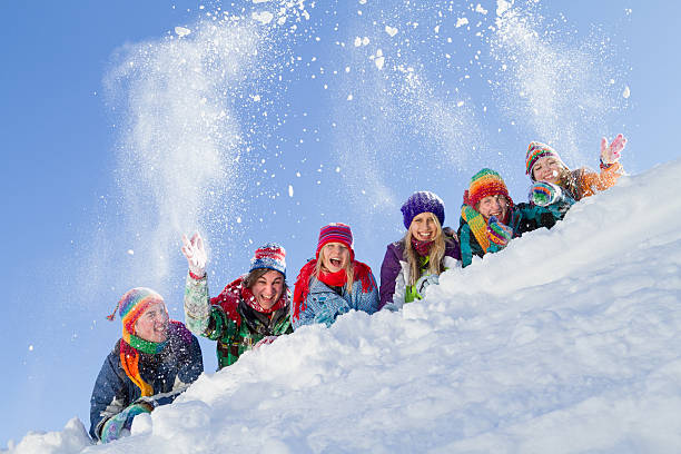 istock Group of happy people lying on hill playing with snow 171582469