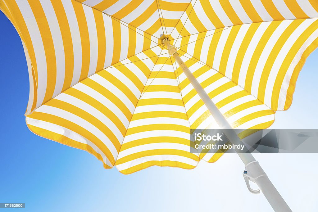 Beach umbrella against blue morning sky - Royaltyfri Strandparasoll Bildbanksbilder