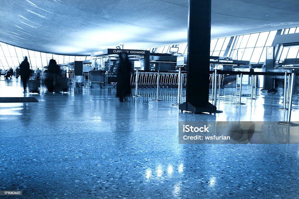 Passenger walking at an airport Photo of  people walking at an airport. Blurred motion. Adult Stock Photo