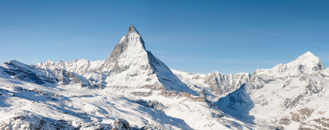 An alpine panorama featuring the iconic peak of the Matterhorn in Switzerland, photographed in winter.