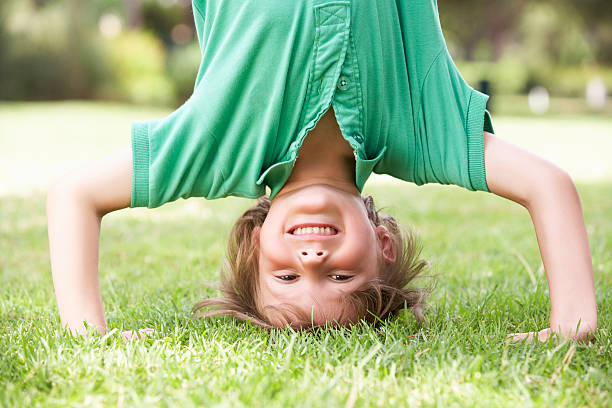 istock Young Boy Standing On Head In Garden 171582679