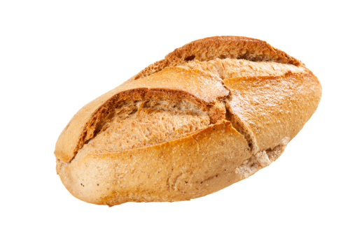 Loaf of brown bread isolated on a white background.