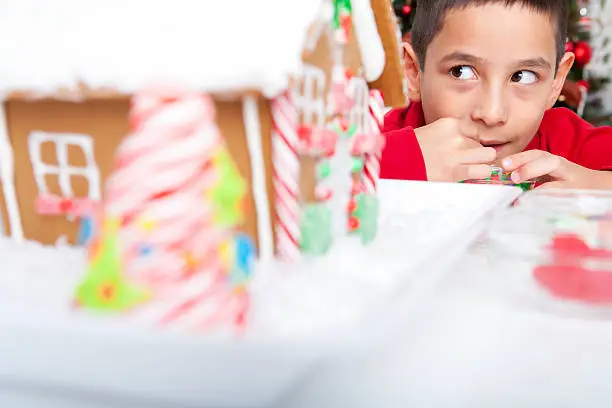 Boy sneaking eating candies