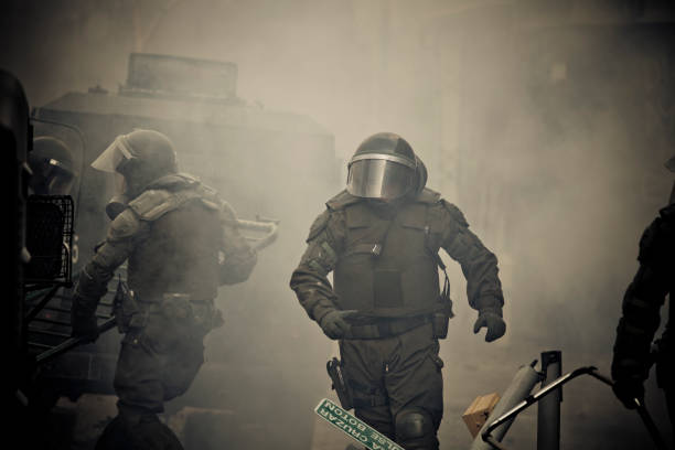 Riot Police Chilean riot police amid tear gas clears barricades during a student strike in Santiago's Downtown, Chile. tear gas stock pictures, royalty-free photos & images