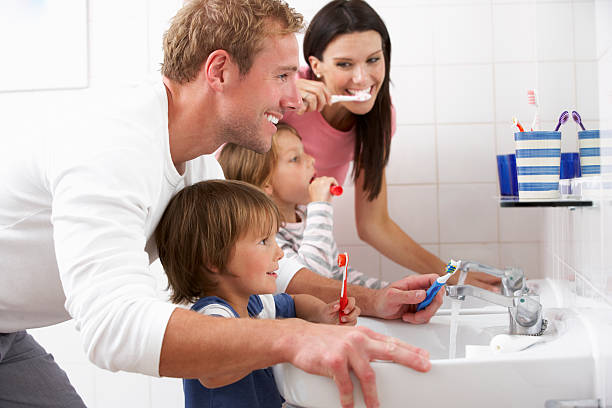 famille dans la salle de bain se brosser les dents - hygiene dental hygiene human teeth child photos et images de collection