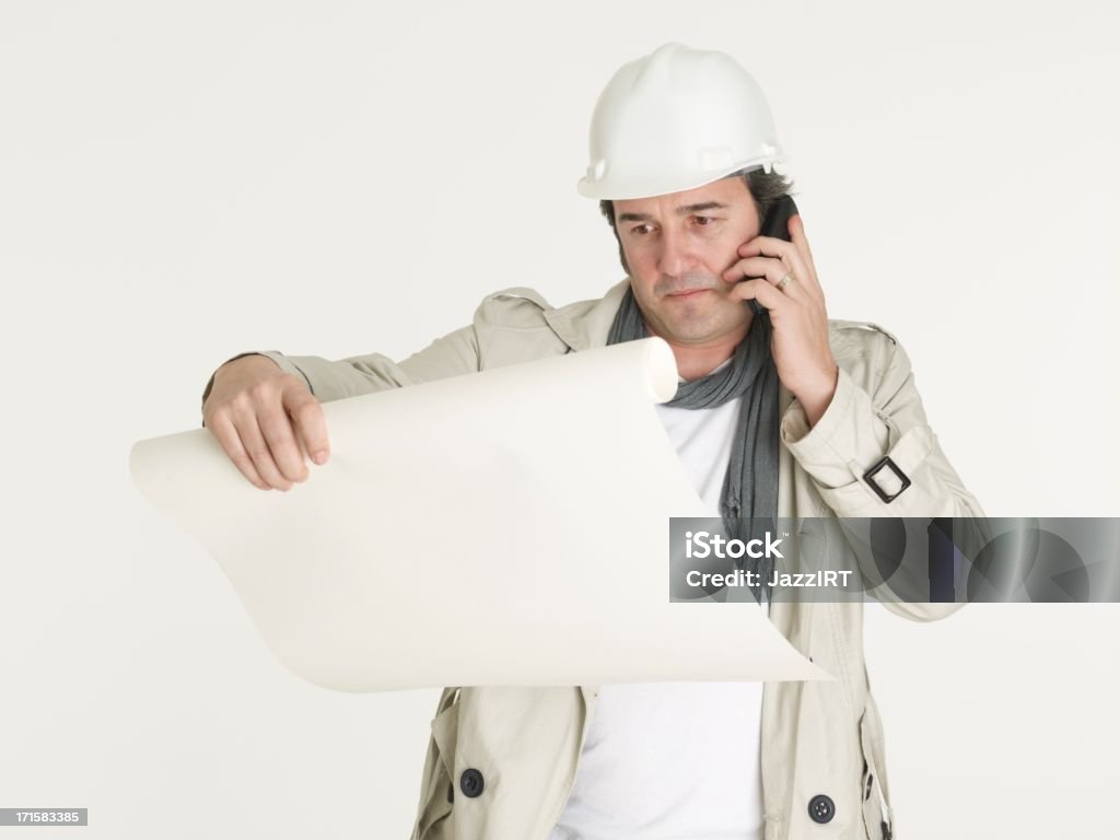 Architect looking at the project and speaks by phone Architect looking at the project and speaks by phonePlease see some similar pictures from my portfolio: Adult Stock Photo