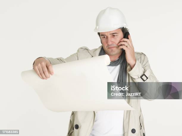 Architect Looking At The Project And Speaks By Phone Stock Photo - Download Image Now