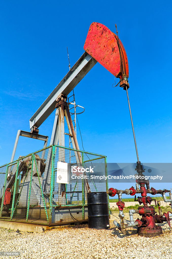 Gas Well Pumpjack The pumpjack and well head of a gas well on the shores of Lake Erie in Southwestern Ontario, Canada. Blue Stock Photo