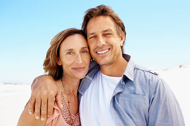 istock Man and woman standing at a beach 171583718