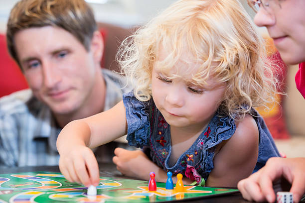 istock Little girl contemplating her next game move 171583828