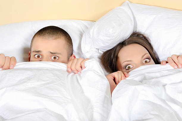 Scared couple with eyes wide open stock photo