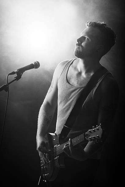 istock Young Rocker Play Guitar in Concert 171583928