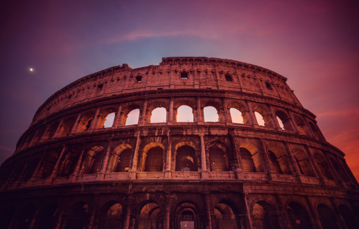 The Coliseum of Rome during a purple sunset