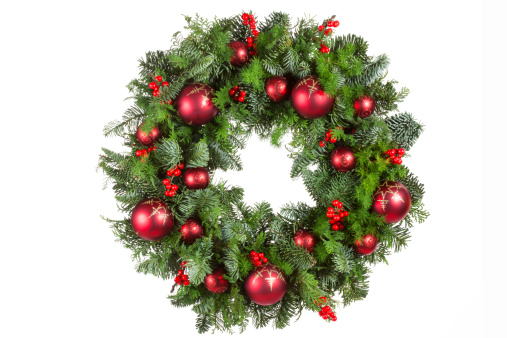 Christmas wreath with Christmas baubles and berries on white background.