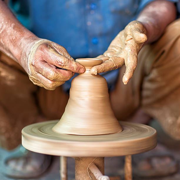 Potter's Hands Molding A Clay Vase