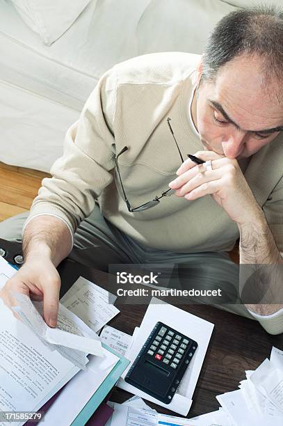 Man Doing Tax Report At Home Stock Photo - Download Image Now - Financial Advisor, Tax Form, 50-54 Years